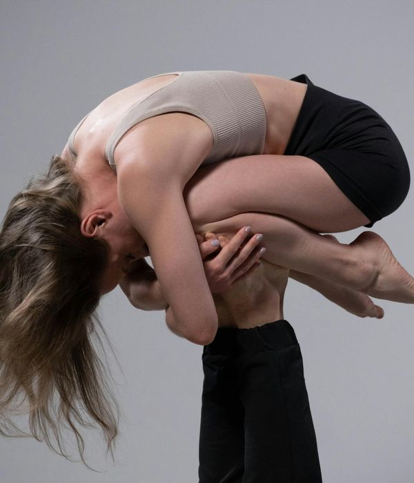 Woman in a dynamic yoga pose symbolizing strength and focus.